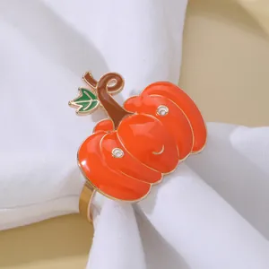 Dettaglio di un portatovagliolo a forma di zucca arancione con finitura dorata