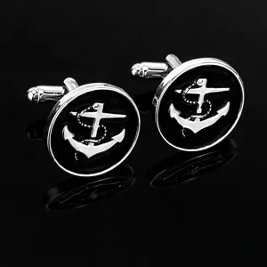 Men's nautical silver anchor cufflinks with black enamel on reflective black background