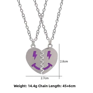 Two-piece silver heart friendship necklace set with purple lightning smile face design