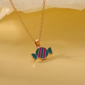 Close-up of a colorful candy-shaped pendant necklace with gold accents and teal finish
