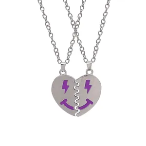 Silver-toned BFF necklaces with split purple heart pendants and smiley face lightning eyes
