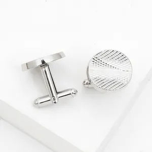 Macro detail of classic silver round cufflinks featuring a refined radial textured pattern