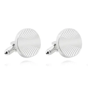 Detailed view of round silver cufflinks with radiant texture and bullet back closure