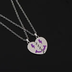 Detail view of heart-shaped puzzle necklace with purple lightning and smile symbols