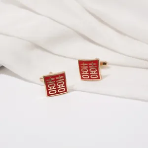 Detailed view of square cufflinks featuring red enamel and gold Double Happiness symbol