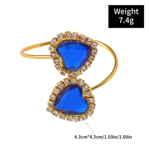 Golden heart napkin ring with blue rhinestones and crystal accents for wedding decor