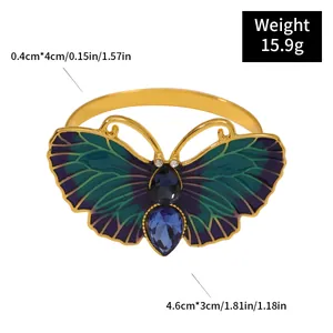 Detalle de servilletero de mariposa con esmalte verde e incrustación de cristal azul