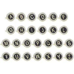 Golden round ring set featuring 26 letters with sparkling crystals on white background