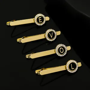 Detailed macro shot of four gold metal pins with LOVE letters and encrusted crystals
