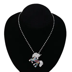 Detail of colorful rhinestones on a silver unicorn pendant necklace for children