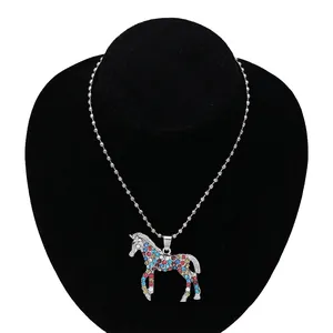 Detail of a children's unicorn pendant with colorful rhinestones on a silver bead chain