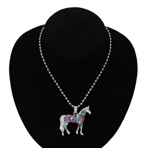 Close-up of unicorn pendant with colorful rhinestones on a silver-tone ball chain