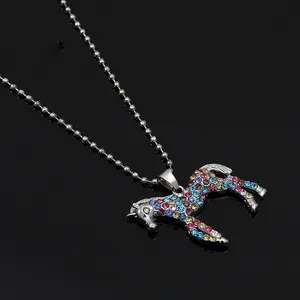 Macro shot of colorful rhinestone-encrusted horse pendant on a silver ball chain