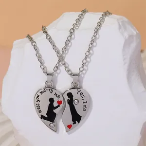 Detail of couple necklace with heart pendant, marriage proposal text and crystal stones