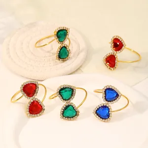 Close-up of heart-shaped jewel napkin rings in red, green and blue on a tray