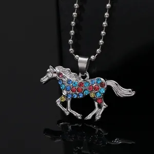Detail of silver unicorn pendant with colorful rhinestones on a metal ball chain