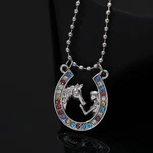 Macro detail of silver horseshoe necklace with colorful rhinestones and beaded chain