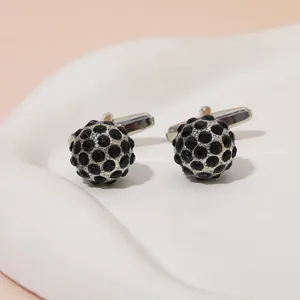 Detailed close-up of spherical cufflinks with silver base and black pavé set crystals