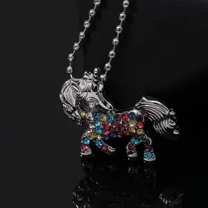 Macro shot of colorful crystal unicorn pendant on polished silver alloy bead chain