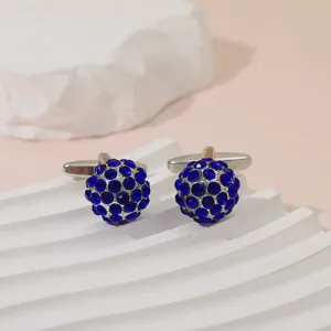 Close-up of elegant round blue crystal cufflinks with silver-toned metal on display