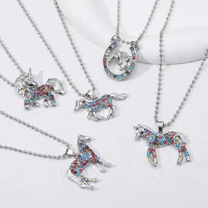 Detail of colorful rhinestone unicorn and horse pendants on beaded chain necklaces
