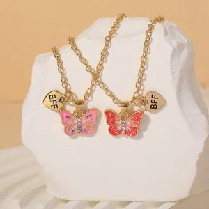 Golden butterfly BFF friendship necklaces with pink enamel charms and rhinestones