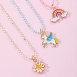 Detail of colorful unicorn, rainbow and daisy pendants on beaded friendship necklaces