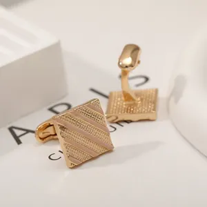 Men's square French cufflinks with gold stripes and pink enamel on elegant white backdrop