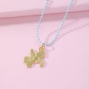 Close-up of golden unicorn pendant with radial texture on a light blue beaded chain