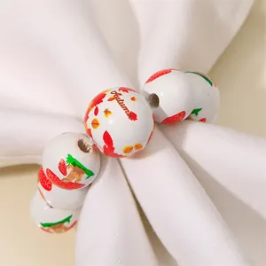 Detail of wooden napkin rings featuring Autumn text and leaf patterns on fabric