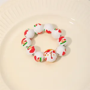 Close-up of wooden bead napkin ring with autumn leaves and mushroom patterns