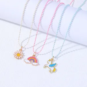 Three BFF necklaces for kids with daisy, rainbow, and unicorn charms on colorful bead chains