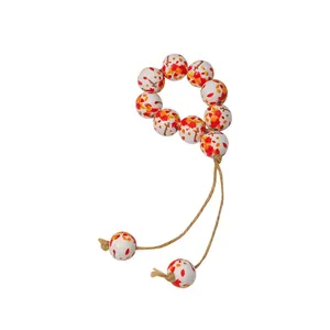 Detail of wooden napkin ring beads with autumn maple leaf patterns and artistic text