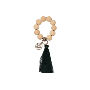 Ethnic wood bead napkin ring featuring bronze owl charm and dark green silk tassel