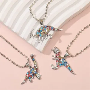 Three colorful dinosaur BFF necklaces with sparkling rhinestones on silver bead chains