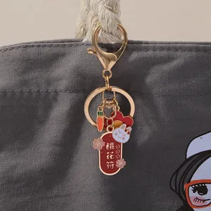 Detail of Chinese style enamel rabbit charm and Peach Blossom talisman on a bag