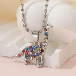 Close-up of dinosaur pendant with colorful rhinestones on a silver bead chain