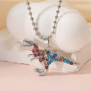 Close-up of T-Rex pendant necklace with colorful rhinestones on a ball chain