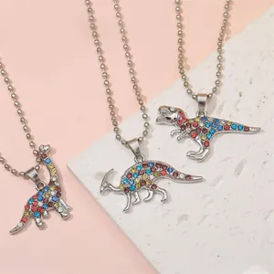 Macro detail of dinosaur BFF necklaces with colorful rhinestones on a display stone