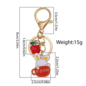 Detailed view of cute white rabbit keychain with apple pendant and size measurements