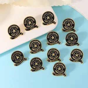 Detailed view of 12 black and gold monthly outstanding employee recognition enamel pins