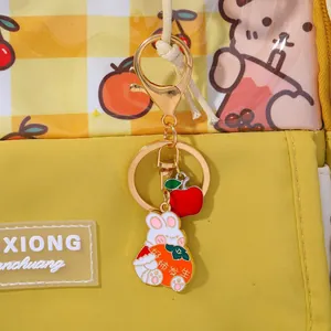 Detail of yellow cherry backpack with white rabbit and persimmon lucky keychain