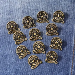 Golden Outstanding Employee enamel pin set with 12 months ribbons on blue denim background