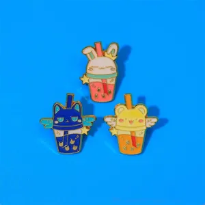 Detailed view of three enamel pins featuring bunny and cat milk tea cup designs