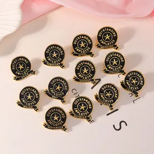 Macro shot of 12 black enamel Outstanding Employee pins with gold metal stars and months