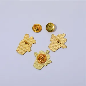 Close-up of golden enamel pins back with diagonal texture and butterfly clutch backs