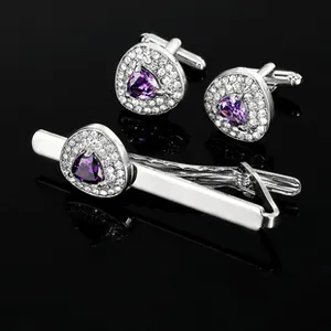 Detail of silver business cufflinks and tie clip set with purple triangular gemstones