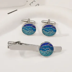Detail of silver business cufflinks and tie clip set with blue mountain enamel inlay