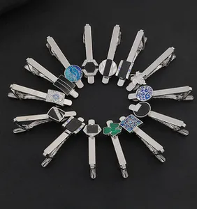 Macro view of assorted silver metal tie clips with enamel and crystal geometric details