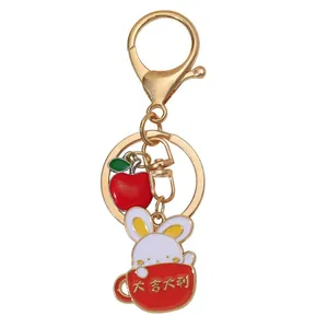 Cute bunny in red cup and apple metal keychain with lucky gold-plated lobster clasp